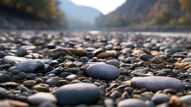 Dry riverbed with smooth stones and pebbles in valley