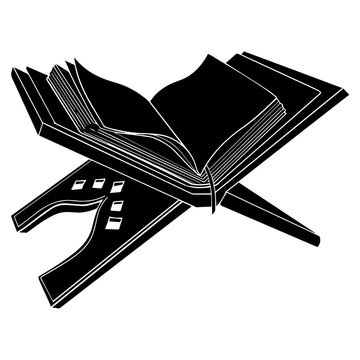 Open black quran book with stand on wooden surface