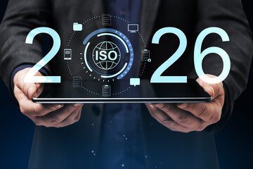 ISO 2026 compliance concept on tablet with digital technology icons, business security, online certification and global standards for mobile devices. © Who is Danny