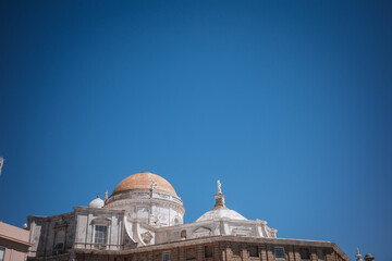 Cathedral with a dome under a blue sky in Cadiz, Spain during daylight © Bohdan