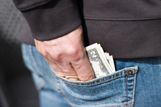 US dollars in the back pocket of a pair of jeans.
