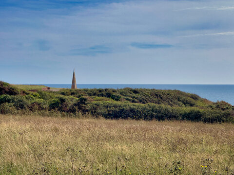 Distant View of the Geoneedle Monument at Orcombe Point Across Coastal Fields in Exmouth Devon UK