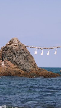 Sakurai Futamigaura shrine white Torii gate with Meoto Iwa Couple Stones, Married Couple Rocks with Shimenawa rope, Itoshima, Fukuoka prefecture, Japan, Kyushu island, landscape in a sunny day