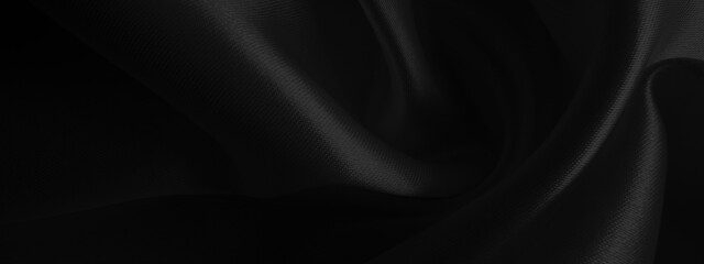Fototapeta premium Close up of black fabric waves background texture