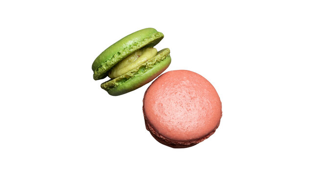 Two colorful macarons green and pink isolated on white background with french macarons colorful cookies almond cookies sweet treats green macaron meringue cookies food photography round cookies