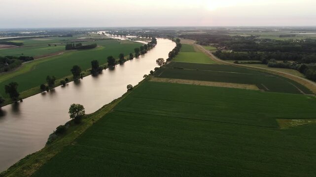 Aerial view of the Maas river winding through green Dutch drone shot