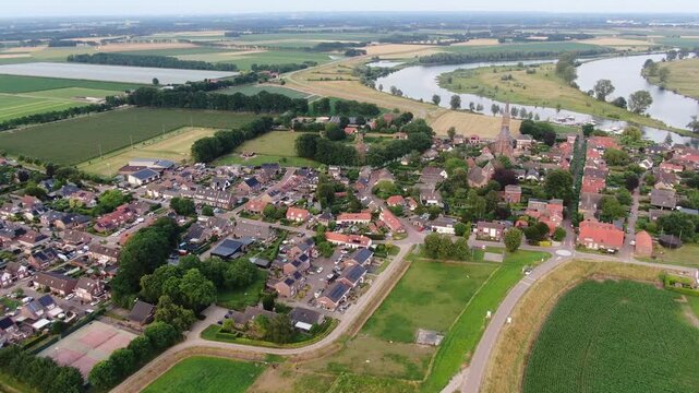 Aerial view of a Dutch village with a church tower beside drone shot