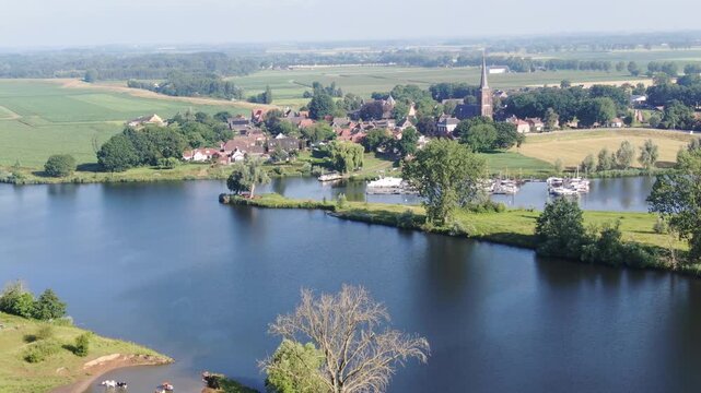 Aerial view of a Dutch village with church tower and marina drone shot