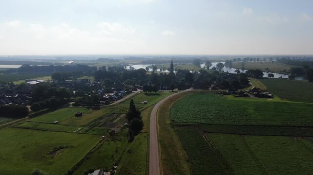 Aerial morning view of a Dutch village church tower beyond drone shot