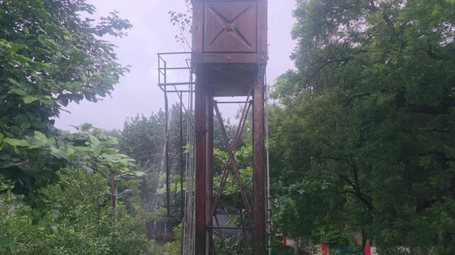 Tall Water Tank Among Dense Trees