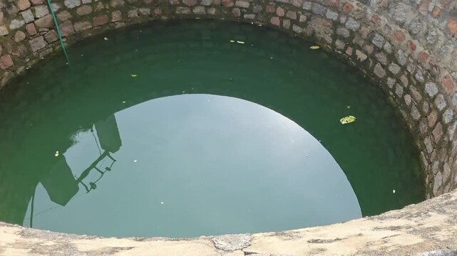 Old Circular Stone Well Filled Water