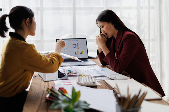 Businesswoman expressing frustration and disappointment during a difficult work discussion, facing critical feedback and poor sales performance data from a demanding colleague
