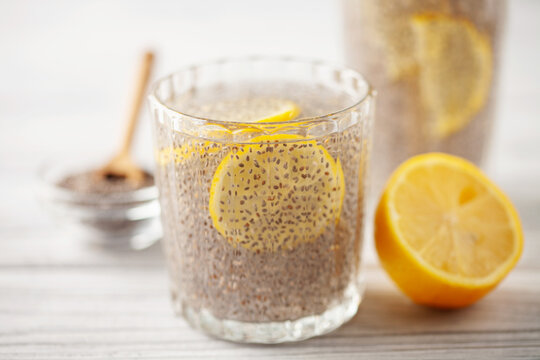 Chia seed water in drinking gasses with lemon slices on wooden table. Drink for a healthy diet