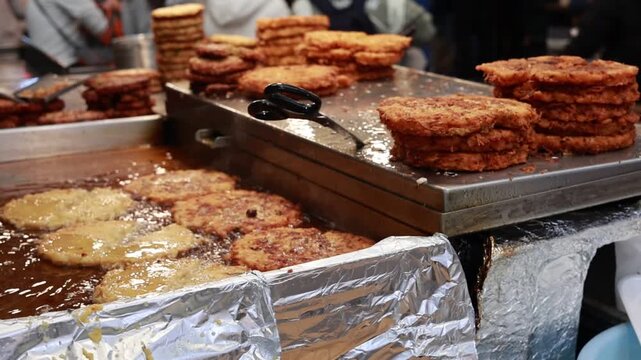 Bindaetteok Mung Bean Pancakes Being Prepared at Gwangjang Market in Seoul, South Korea
