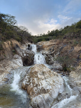 Wide waterfall flow in stone bank