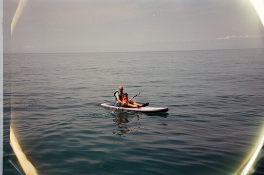 Man and Child on a Paddleboard, Framed Shot"