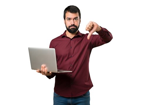 Bearded man in a maroon shirt holding a laptop and showing a thumb down sign