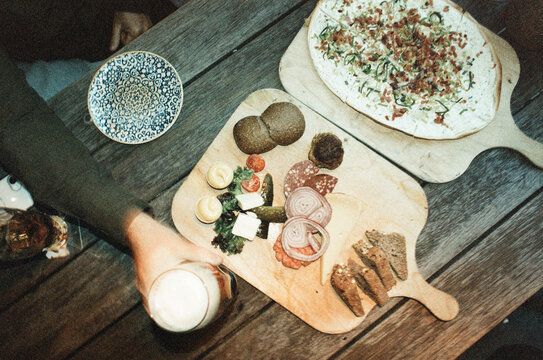Charcuterie board and flatbread on rustic wooden table