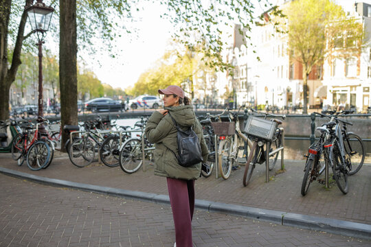 Woman looking at parked bicycles in Amsterdam Holland
