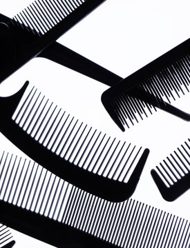 A set of black combs on a  white background.