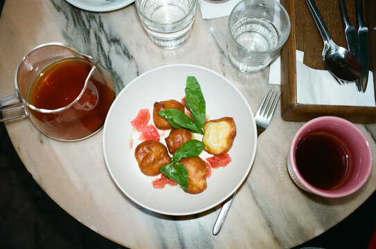 Food Served on a Table With Drinks and Utensils Around
