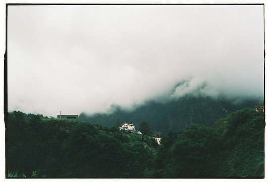 Lone White House on Misty Forested Hillside in Madeira Portugal