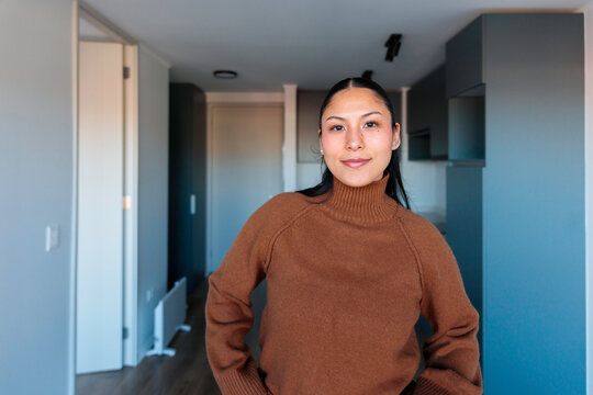 Smiling woman inside modern apartment