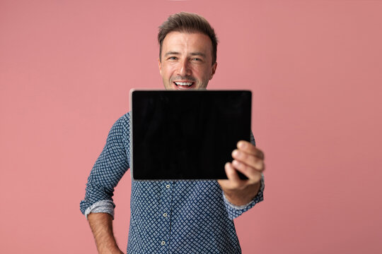 Happy man presenting digital tablet with blank screen