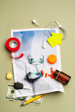 Scattered daily objects and  spilled pills on glass of water photo