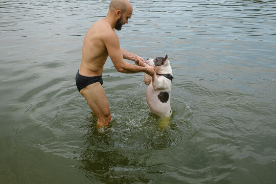 Happy Man Playing Dog In Water Summer Lake Activity