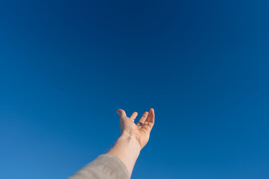 Open Hand Reaching Toward Blue Sky