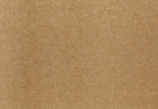 Kraft paper texture with dense brown fibers and scattered dark specks in a blank sheet, a matte packaging background with pressed pulp grain for scrapbook pages and collage