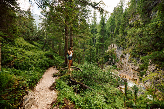Woman visits Cascate di Fanes in the Dolomites. Italy