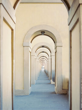 Arched stone corridor with repeating pillars architectural perspective