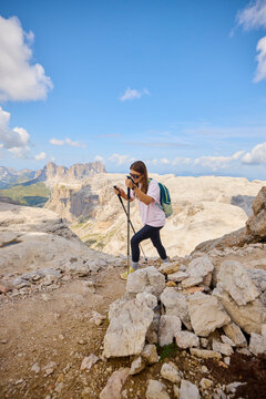 Hiker Exploring Rocky Terrain in the Mountains on a Sunny Day