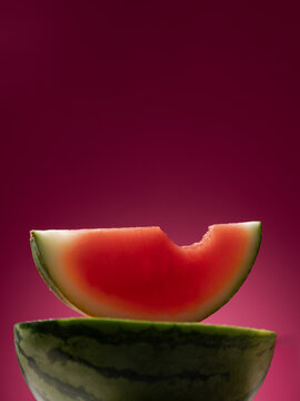 A vibrant close-up of a bitten watermelon slice