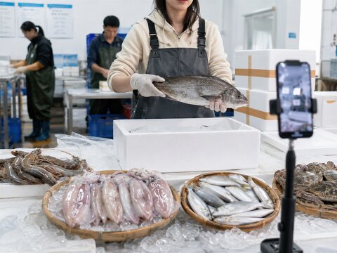 Woman Recording Seafood Product Video in a Processing Facility