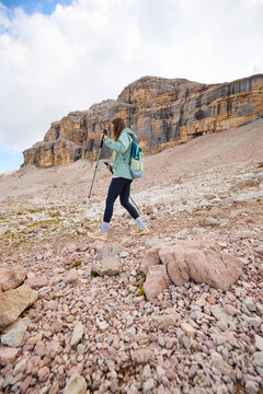 Woman navigates rocky terrain in the Dolomites.