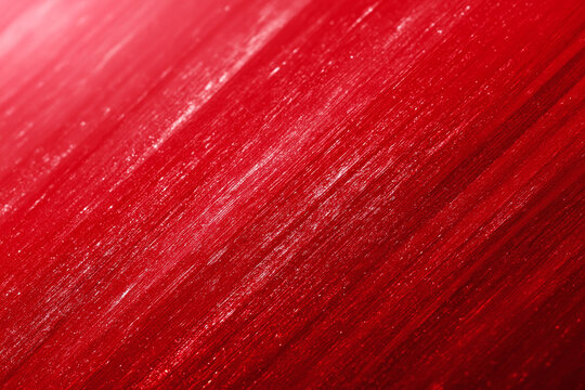Minimal crimson field red texture with diagonal brushed strokes and subtle glitter sheen, abstract closeup conveying bold color intensity and tactile metallic finish