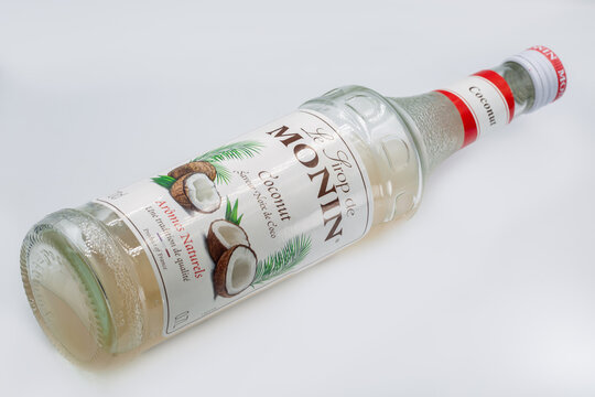 Monin coconut syrup flavored drink mixer bottle closeup on white.