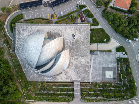 Rijeka, Croatia - 05 18 2025: Top down drone photo of the Islamic Center of Rijeka (Islamski centar u Rijeci) centered in the frame, showing the street on the right and a parking lot in front 