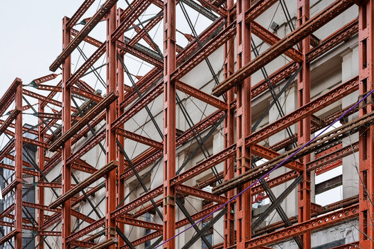 Red steel framework on new commercial building under constructio