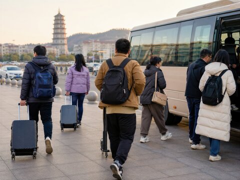 Group of tourists boarding a bus near a pagoda in a city