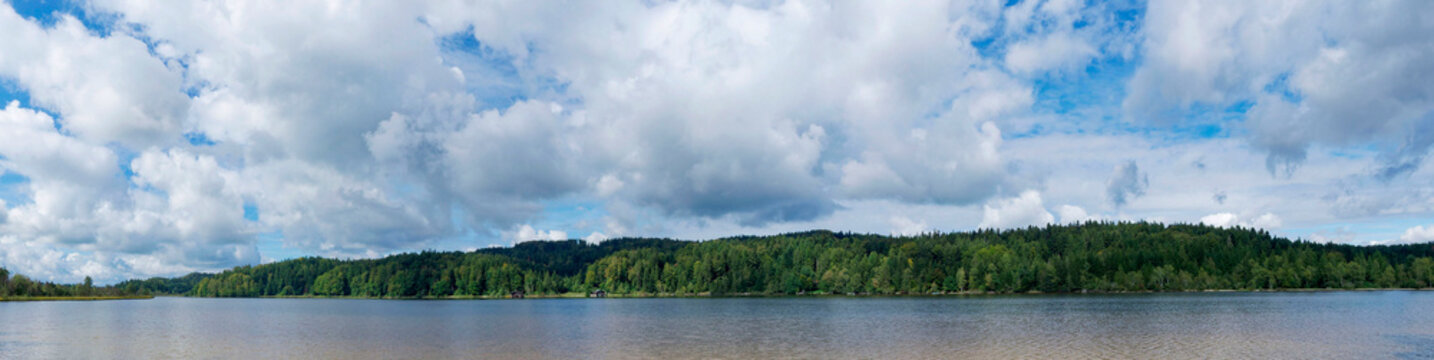 Kirchsee one of the most beautiful swimming lakes in Bavaria in the heart of the Ellbach-Kirchseemoor nature reserve. View of the North Bank
