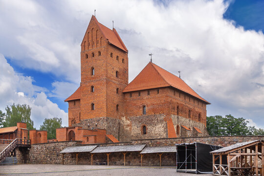Courtyard view of Trakai Island Castle with main palace tower in Lithuania. Brick gothic architecture under partly cloudy sky