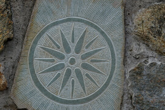 The Vergina Sun or Star of Vergina on a stone bas-relief