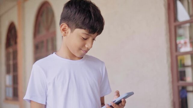 Young boy using a smartphone outdoors
