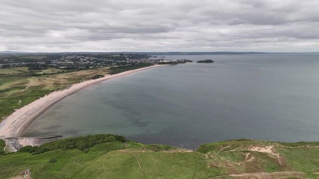 Aerial Drone View of Curved Sandy Beach Bay and Coastline Near Tenby in Pembrokeshire Wales