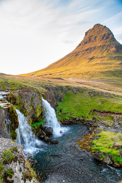 Iconic Kirkjufellsfoss waterfalls and Iceland landscape at golden hour.
