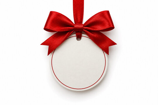 Elegant circular blank paper price tag suspended by a luxurious vibrant red satin ribbon bow against a clean white background perfect for festive holiday gift labels or special promotional branding
